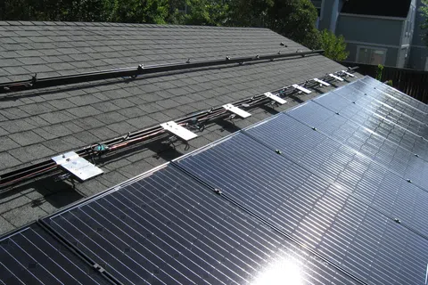Residential rooftop solar panels installed on an asphalt shingle roof with Enphase microinverters