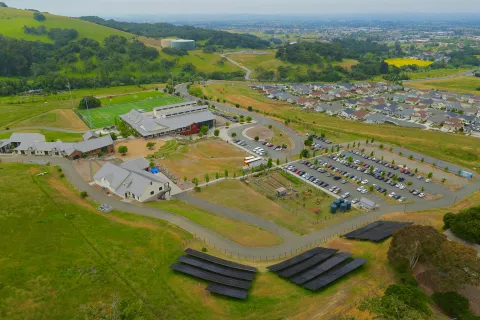 a large green landscape with buildings and trees