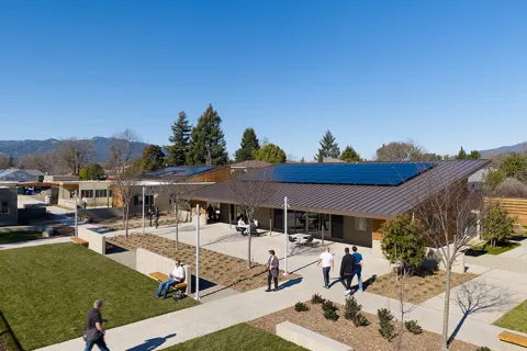 a building with a courtyard and people walking around