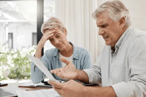 a man and a woman looking at a paper