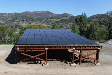 A solar panel installation situated in a mountainous landscape, showcasing renewable energy use in nature.
