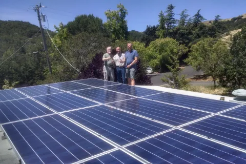 a group of people standing on a solar panel