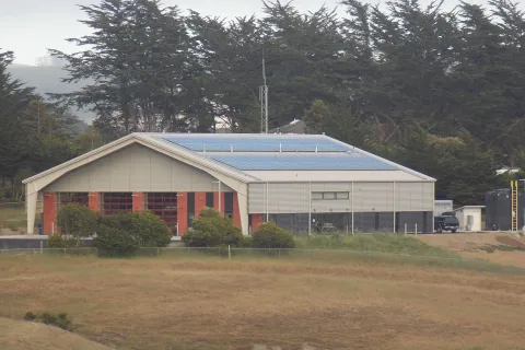 a building with a field in front of it