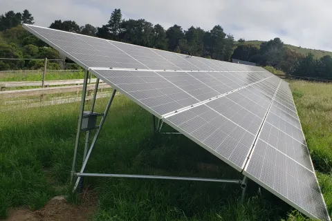 a solar panel on a grassy field