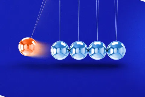 Orange metal sphere striking silver spheres in a Newton's cradle on a blue background.