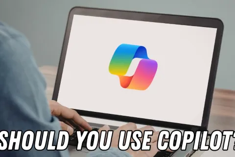Person typing on laptop displaying colorful Copilot logo with text 'Should you use Copilot?'