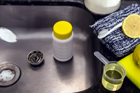 A spoon with salt and sink, toothbrush and lemon