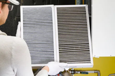 a man wearing a white lab coat and gloves working on a machine