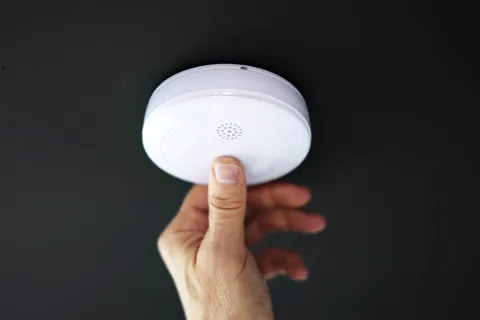 a hand holding a white disc