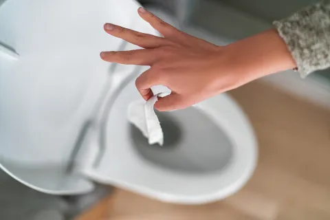 a hand holding a white paper