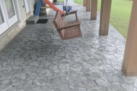 a bench on a stone patio