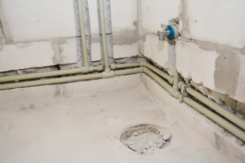 a dirty room with pipes