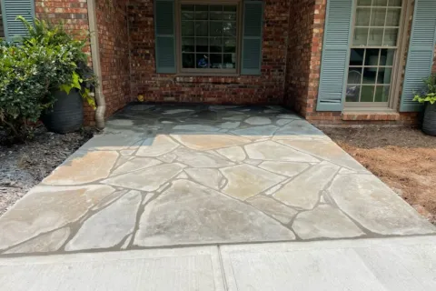 a stone walkway in front of a brick building