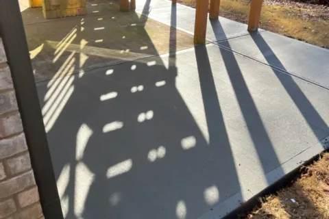 a shadow of a person on a deck