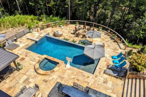 a pool with a deck and chairs