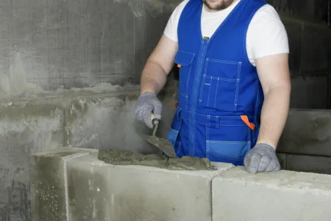 a person wearing a safety vest and holding a shovel
