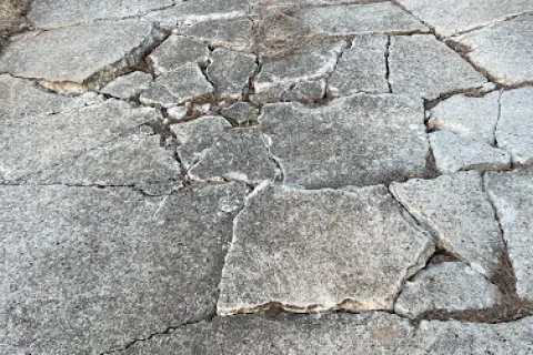 a cobblestone road with cracks