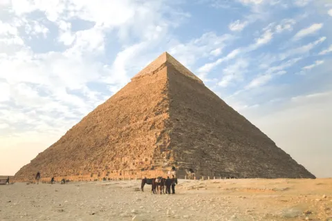 a pyramid with people on horses