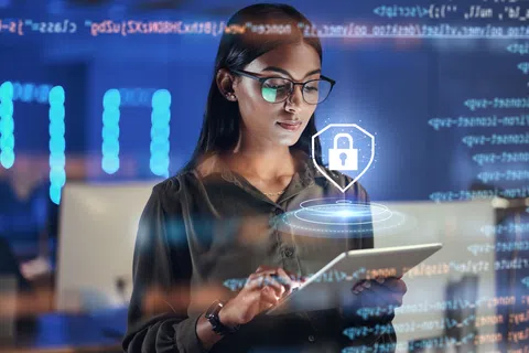 Woman using tablet with digital lock and code overlay illustrating cybersecurity and data protection.