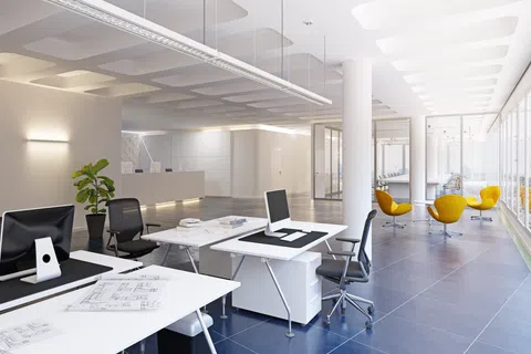 Modern bright office interior with white desks, black chairs, yellow lounge chairs, and large windows.