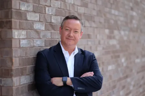 a man leaning against a wall