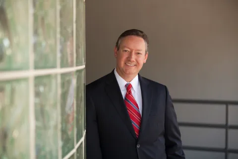 a man in a suit smiling