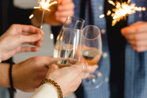 a group of people holding wine glasses