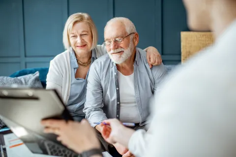a man and a woman looking at a laptop