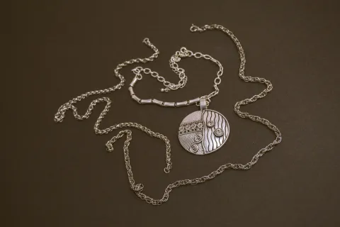 a necklace with a diamond pendant
