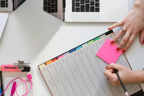 a person writing on a piece of paper