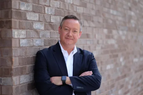 a man leaning against a wall