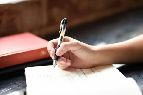 a hand holding a pen