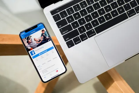 a cell phone next to a laptop