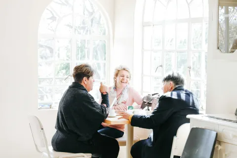 a group of people sitting around a table