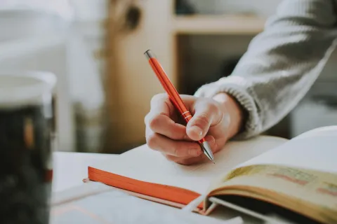 a person writing on a book