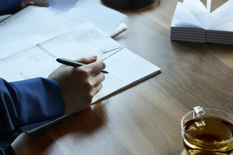 a person writing on a piece of paper