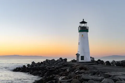 a lighthouse on a rocky beach