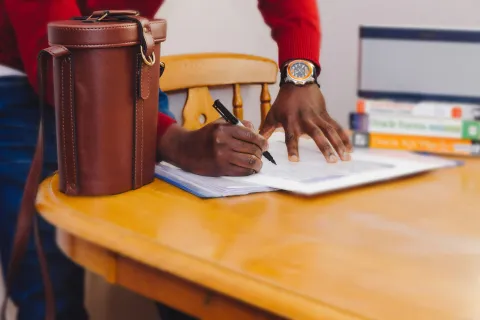a person writing on a piece of paper