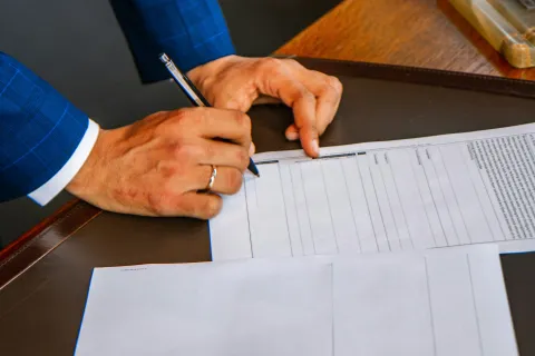 a person writing on a piece of paper