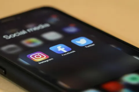 Close-up of smartphone screen showing Instagram, Facebook, and Twitter apps in Social media folder.