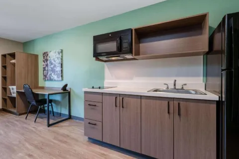 Echo Suites by Wyndham Guestroom Kitchen Cabinets and Quartz Countertops