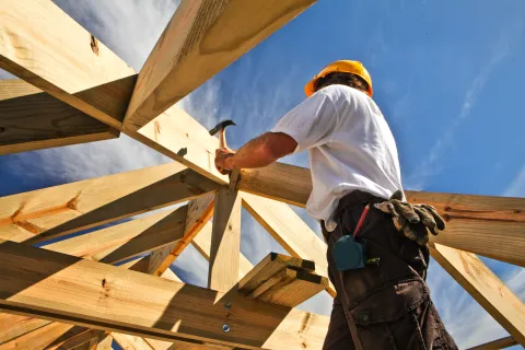 a man building a roof