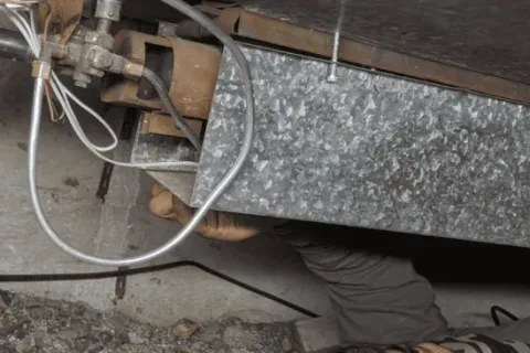 a technician from Total Home Environmental working on a floor furnace in Torrance