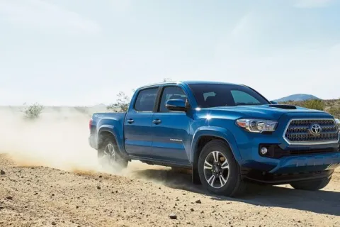 a blue truck on a dirt road