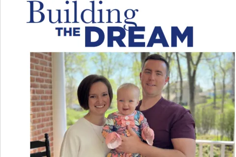 a man and woman holding a baby