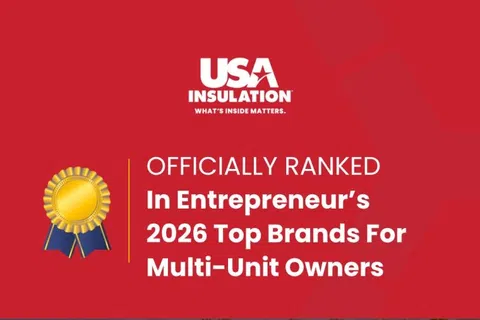 USA Insulation trucks lined up under a banner announcing 2026 Entrepreneur's Top Brands for Multi-Unit Owners award.