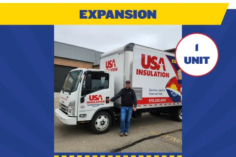 Man standing beside USA Insulation truck with branding and contact info in Denver, Colorado for business expansion.
