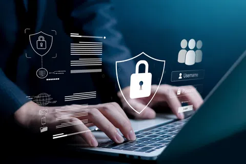 User typing on laptop keyboard with digital security icons including padlock and login interface overlay.