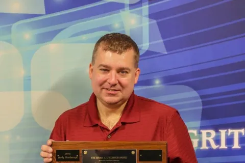 a man holding a plaque