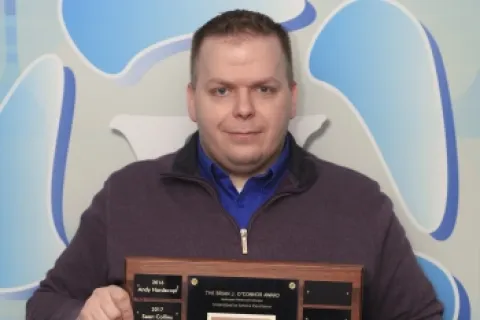 a man holding a plaque